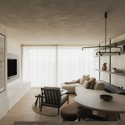 Zithoek met fauteuil, ronde salontafel en schilderij voor ramen met vitrage, Appartement in Nieuwpoort, interieur Laura Calleeuw