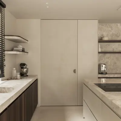 Keuken met natuurstenen werkblad en spoelbak, kookplaat en een verborgen kastdeur, Gezinsvilla in Heusden-Zolder, interieur Laura Calleeuw