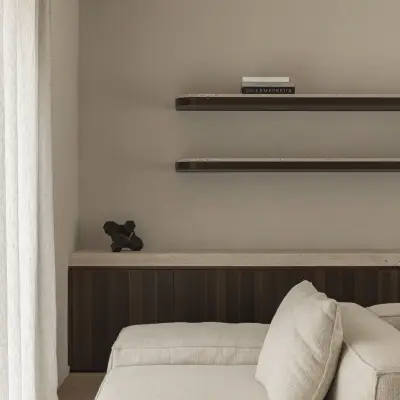 Hoek van de sofa onder wandplanken met indirect licht, Gezinsvilla in Heusden-Zolder, interieur Laura Calleeuw