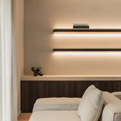 Hoek van de sofa onder wandplanken met indirect licht, Gezinsvilla in Heusden-Zolder, interieur Laura Calleeuw