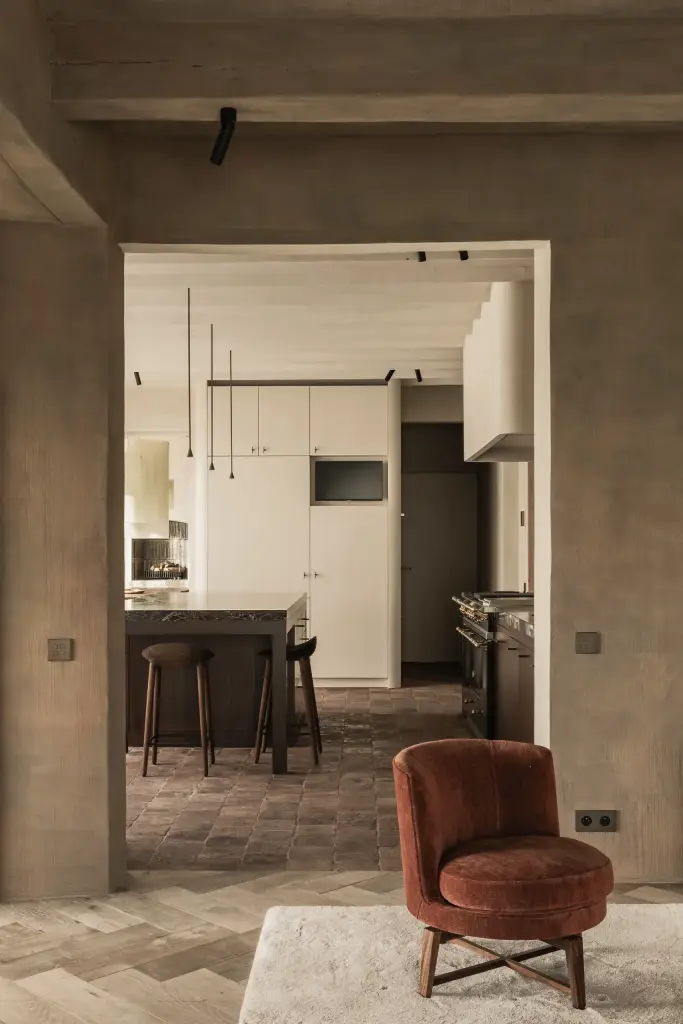 Doorkijk door de gang naar de keuken met een fauteuil op de voorgrond, Hoeve in Westkapelle, interieur Laura Calleeuw
