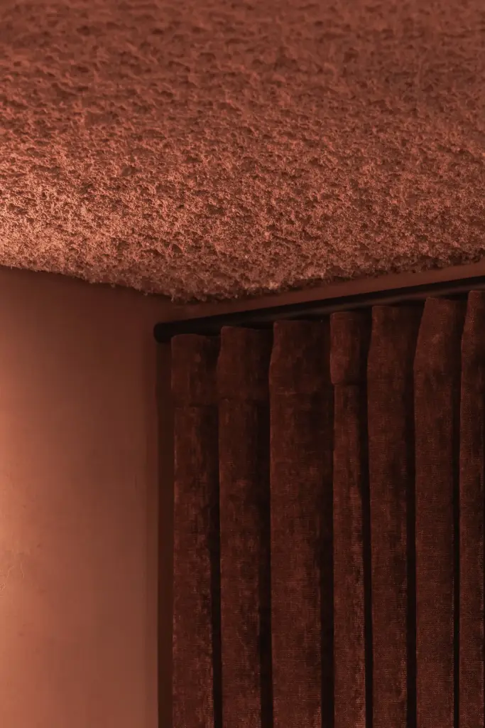 Fluwelen gordijn en een gestructureerd plafond in terracotta, Hoeve in Westkapelle, interieur Laura Calleeuw