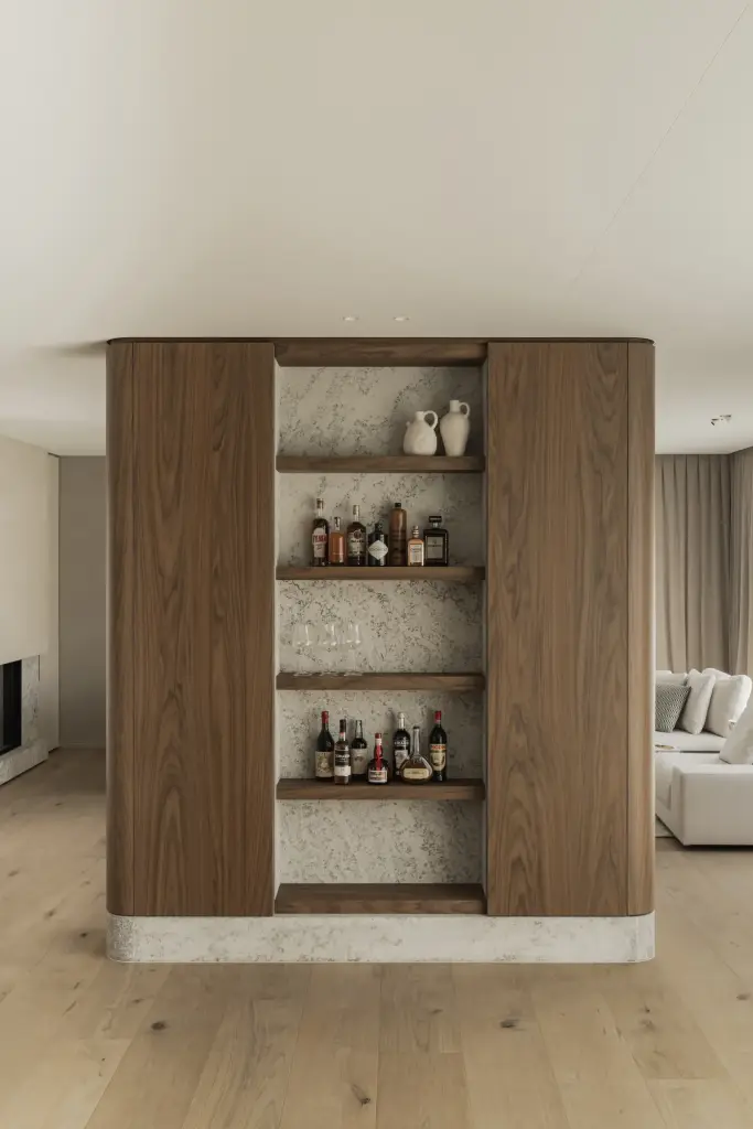Barnis in notelaar met planken en flessen in de leefruimte, a masterful balance between authenticity and comfort, interieur Laura Calleeuw