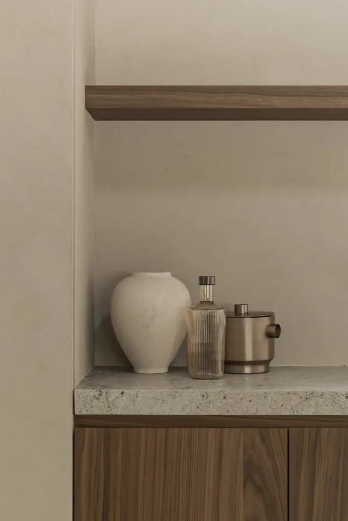 Schap met vazen en karaffen boven een natuurstenen blad, a masterful balance between authenticity and comfort, interieur Laura Calleeuw
