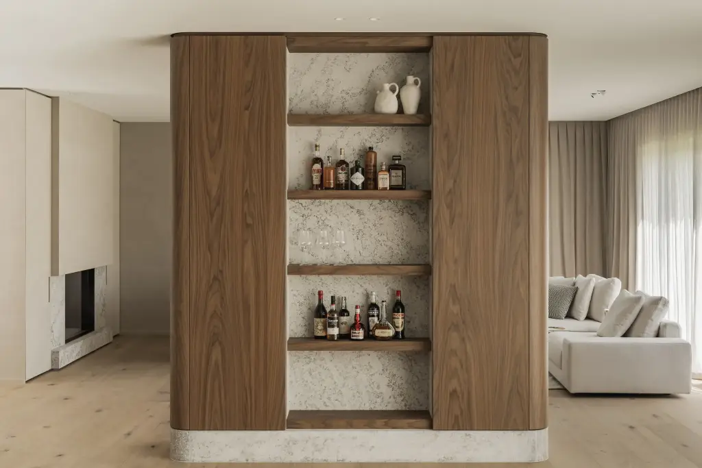 Leefruimte met barnis in notelaar, flessen op planken, haard in natuursteen en een hoeksofa, a masterful balance between authenticity and comfort, interieur Laura Calleeuw