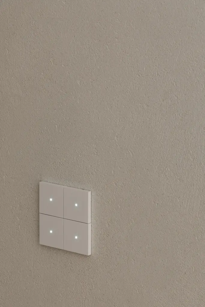 Lichtschakelaar met vier knoppen op een gepleisterde wand, Penthouse in Kortrijk, interieur Laura Calleeuw