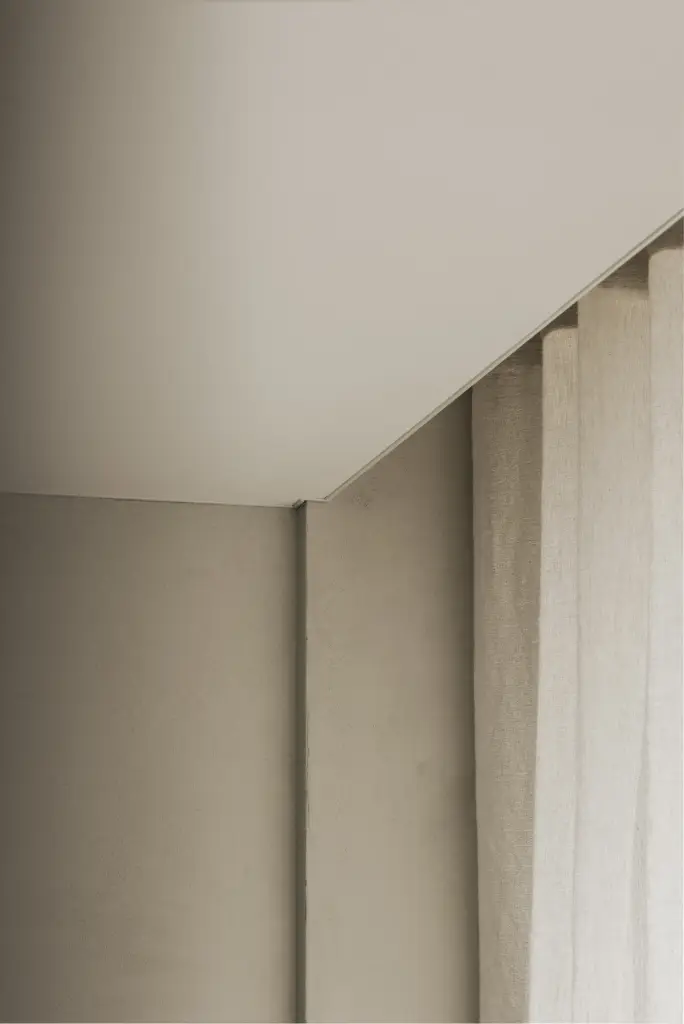 Gordijn in een gepleisterde hoek onder een wit plafond, Kantoor KBC in Ardooie, interieur Laura Calleeuw