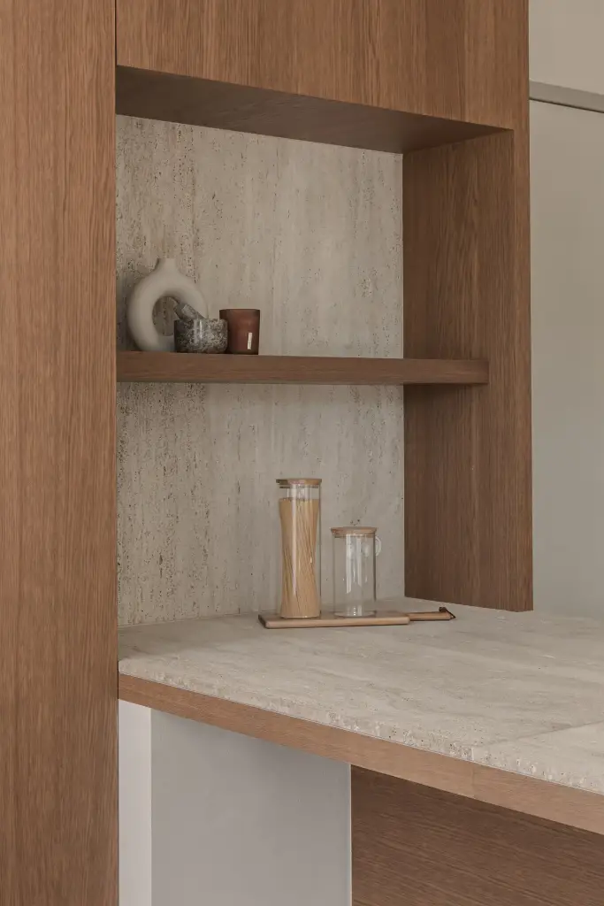 Nis met eikenhouten plank, vaas en glazen potten tegen een travertijnen wand, Herenhuis in Roeselare, interieur Laura Calleeuw