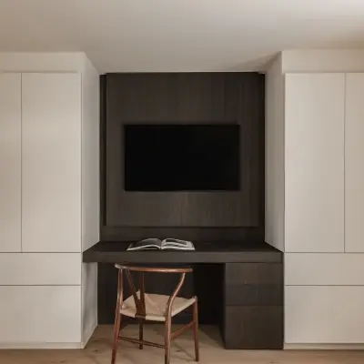 Bureau met televisie in donker eiken tussen witte kasten en gordijn, Schuur in Westkapelle, interieur Laura Calleeuw