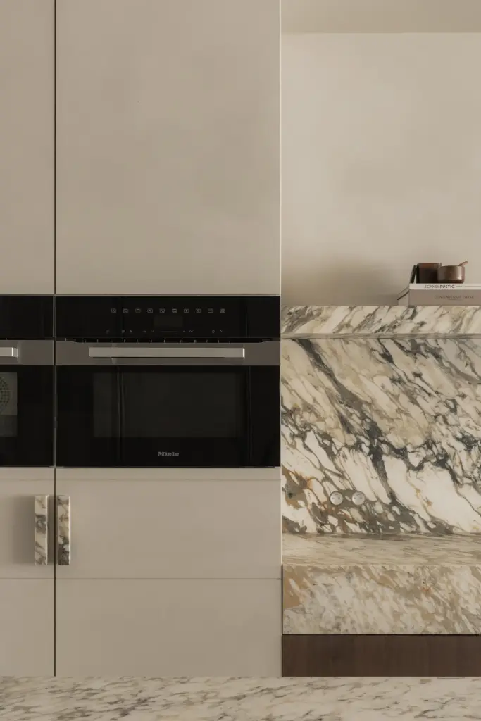 Twee inbouwovens in een kastenwand naast een natuurstenen achterwand, Het Zoute Schorre, interieur Laura Calleeuw