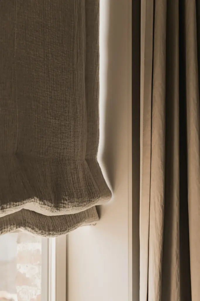 Linnen rolgordijn met golvende rand voor het raam en radiator, Herenhuis in Brugge, interieur Laura Calleeuw