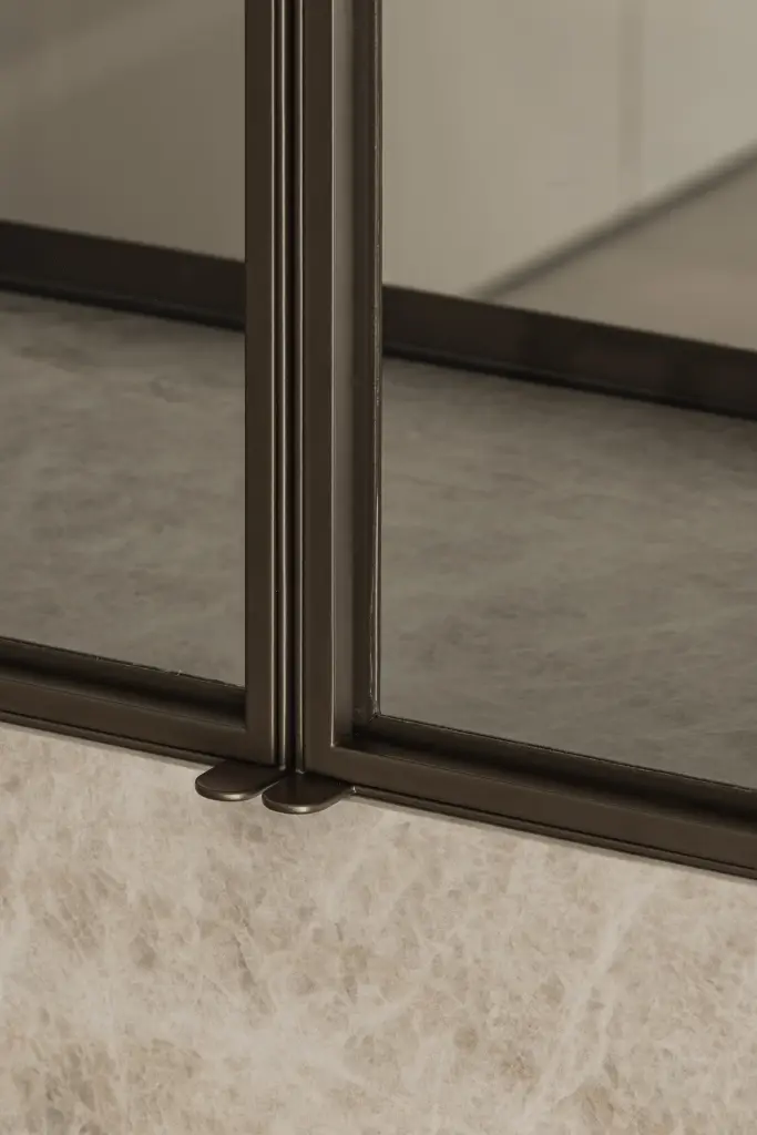 Detail van een stalen glazen deur en natuurstenen sokkel, Villa in Loppem, interieur Laura Calleeuw