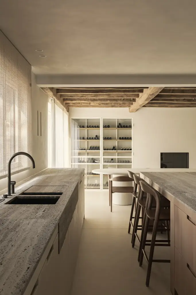 Doorkijk langs het keukeneiland naar de wijnkast en eethoek, Totaalrenovatie in Loppem, interieur Laura Calleeuw